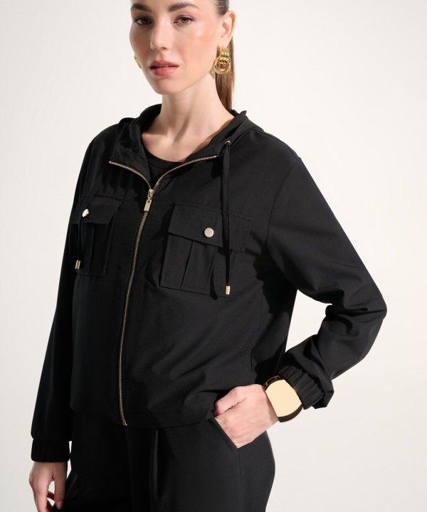 Elevated black hooded utility jacket with gold accents, stylish and versatile, perfect for fashion-forward women seeking comfort and chic streetwear.