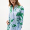 Stylish women's button-up shirt with vibrant green floral pattern and blue stripe details, perfect for fashion-forward outfits and summer wardrobe essentials.