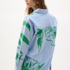 Blue striped shirt with green floral print by KATYAMAKER, perfect for modern casual wear and artistic fashion statements.