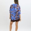 Bright blue floral blouse with button details, styled casually for everyday wear.